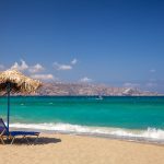Blue sun loungers with parasol on a beach near Heraklion, Crete